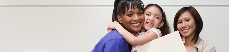 Hospital tech hugging child patient